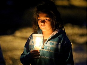A candlelight prayer vigil was held as darkness fell over Attawapiskat on Friday, April 15, 2016, with about 70 residents praying and singing as they walked through the streets.