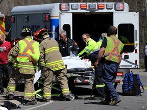 Paramedics carry a person to a ambulance after an accident on Highway 43 and South Gower Drive near Kemptville Saturday. Firefighters used the jaws of life to remove the accident victim.