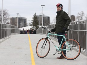Bike lanes are planned for McArthur Avenue in Vanier. The lanes would connect to the Adàwe crossing, which opened in 2015, via the Rideau River Eastern Pathway. Here, Coun. Mathieu Fleury is pictured on the bridge.