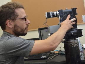 Algonquin College mechanical engineering student Joseph Dupuis — whose off-the-grid cabin went viral last spring — displays an early prototype of his solar tracking device in September 2015.