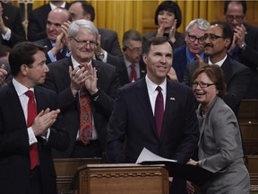 Public Services and Procurement Minister Judy Foote, right, jokes with Minister of Finance Bill Morneau as he delivers the federal budget in the House of Commons on March 22. The government's treatment of the parliamentary budget officer, however, is no joking matter.