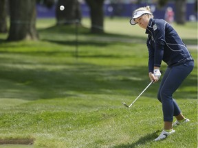 Brooke Henderson, of Canada, chips the ball onto the first green of the Lake Merced Golf Club during the final round of the Swinging Skirts LPGA Classic golf tournament Sunday, April 24, 2016, in Daly City, Calif.