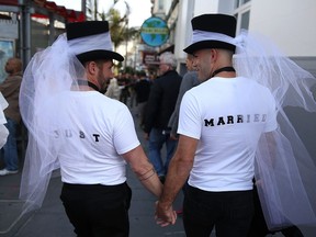 SAN FRANCISCO, CA - JUNE 26:  Same-sex marriage supporters wear just married shirts while celebrating the U.S Supreme Court ruling regarding same-sex marriage on June 26, 2015 in San Francisco, California. The high court ruled that same-sex couples have the right to marry in all 50 states.