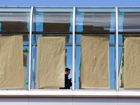 City hall has had a problem with birds injuring or killing themselves after flying into the glass domed bridge between the Heritage building and the main building and so a temporary solution is to tape brown paper on the glass.  So far it seems to have worked.