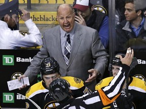 Boston Bruins coach Claude Julien argues with an official during overtime of an NHL hockey game against the Carolina Hurricanes in Boston, Tuesday, April 5, 2016. The Hurricanes defeated the Bruins 2-1 in a shootout.