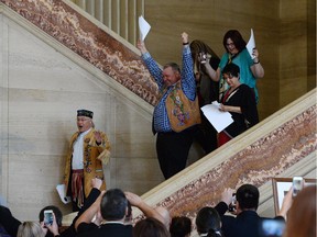 Metis National Council President Clement Chartier, left, and David Chartrand, president of the Manitoba Metis Federation, centre, celebrate following the decision at the Supreme Court of Canada in Ottawa on Thursday, April 14, 2016.