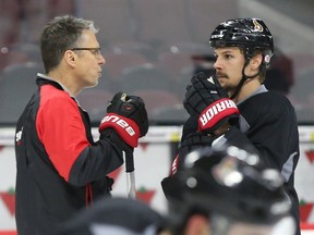 Coach Dave Cameron and Erik Karlsson of the Ottawa Senators chat during morning practice at Canadian Tire Centre in Ottawa, April 06, 2016.   Photo by Jean Levac