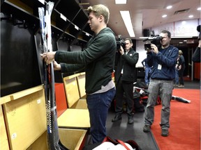 Ottawa Senators' Curtis Lazar tapes up his sticks as the team clears out of the locker room at the end of the NHL season on Monday, April 11, 2016 in Ottawa.