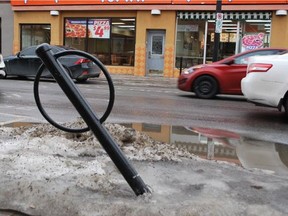 A bike stand bollard knocked sideways by a snowplow on Wellington Street over the winter.