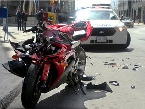 Debris from a motorcycle involved in an accident at the corner of Kent and Slater is scattered about on Slater Street Thursday, April 28, 2016.