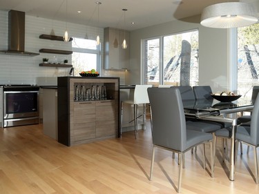 A contemporary kitchen and floors in red birch reclaimed from the Ottawa River add to the light, airy style.