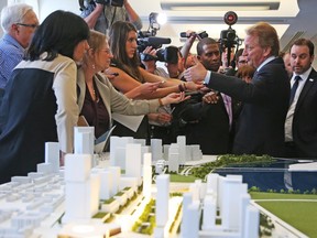 Eugene Melnyk talks to the media in front of his winning proposal of the Lebreton Flats redevelopment in Ottawa, April 28, 2016.