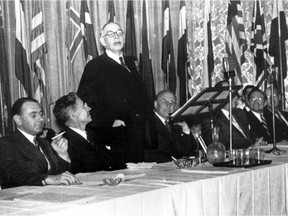 A picture from the International Monetary Fund shows British economist Lord John Maynard Keynes (3rd L) addressing the Bretton Woods Conference, in July 1944.