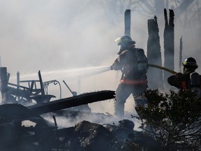 Fire fighters battle a house fire on Sills Road on Friday in Belleville, Ont.