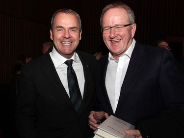 From left, Stephen Wallace, secretary to the Governor General, at the National Arts Centre on Tuesday, April 19, 2016, with former Clerk of the Privy Council Wayne Wouters, seen holding a couple of copies of Gov. Gen. David Johnston's new book, launched that night as part of the Ottawa International Writers Festival. (Caroline Phillips / Ottawa Citizen)