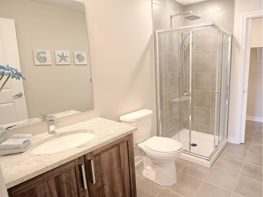 The two-bedroom unit includes a second three-piece bath that leads to the laundry room.