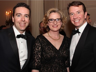 From right, Treasury Board president Scott Brison with his husband, Maxime St. Pierre, and Emmanuelle Latraverse, Ottawa bureau chief for Radio-Canada, at the Politics and Pen dinner held at the Fairmont Chateau Laurier on Wednesday, April 20, 2016, in support of The Writers' Trust of Canada.