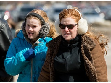 Garth Brooks fans make their way in the bitter cold wind outside of the Canadian Tire Centre on Sunday April 3, 2016.