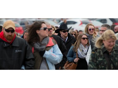 Garth Brooks fans make their way in the bitter cold wind outside of the Canadian Tire Centre on Sunday April 3, 2016.