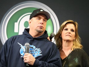 Garth Brooks and Trisha Yearwood listen to a question during an afternoon press conference.