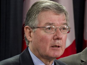 John McDougall responds to a question during a news conference Tuesday May 7, 2013 in Ottawa.