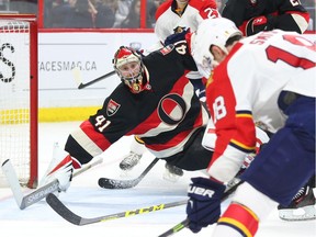 Goalie Craig Anderson (L) of the Ottawa Senators follows the puck as Reilly Smith of the Florida Panthers can't get a shot off in the open net during second period of NHL action at Canadian Tire in Ottawa, April 07, 2016.