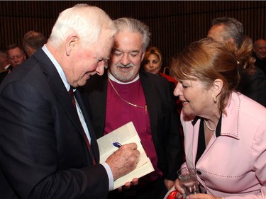 Gov. Gen. David Johnston signs a copy of his new book, The Idea of Canada: Letters to a Nation, for Anglican Bishop John Chapman and his wife, Catherine, at the book launch held at the National Arts Centre on Tuesday, April 19, 2016, as part of the Ottawa International Writers Festival.
