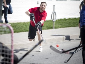 Hamilton Avenue North between Spencer Street and Wellington Street were shut down for a Hintonburg Street Hockey Tournament Saturday April 16, 2016. Money raised went to the Parkdale Food Centre. Matt Lavoie takes a shot.