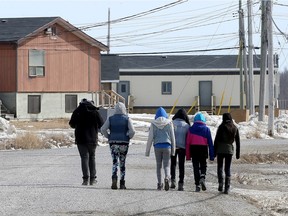 People walk through Attawapiskat, a northern Ontario indigenous community.
