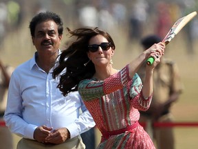 Former Indian cricketer Dilip Vengsarkar looks on as Catherine, Duchess of Cambridge(R)and Britain's Prince William, Duke of Cambridge play a game of cricket with Indian children who are beneficiaries of NGO's at The Oval Maidan in Mumbai on April 10, 2016. /