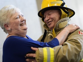 Janice Elliott and Ed Bigelow share a laugh after Ed dressed up as a firefighter to surprise his wife after a wedding ceremony held at Carleton University on Saturday, April 9, 2016.