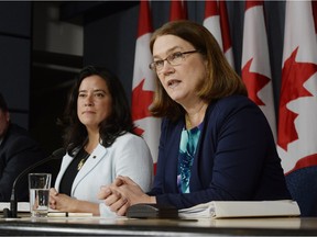 Health Minister Jane Philpott, right, speaks as Justice Minister Jody Wilson-Raybould looks on at a news conference in Ottawa on Thursday, April 14, 2016. The federal government has introduced a long-awaited and controversial new law spelling out the conditions in which seriously ill or dying Canadians may seek medical help to end their lives.