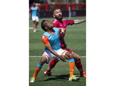 Jonny Steele of the Ottawa Fury FC battles Miami FC's Dane Richards for the ball during the Fury's home-opener Saturday April 30, 2016 at TD Place.   Ashley Fraser