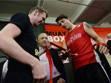 Prime Minister Justin Trudeau has his hands wrapped by professional boxer Yuri Foreman.
