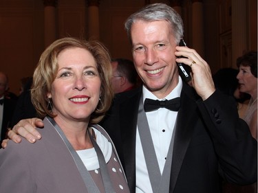 Liberal MP Kim Rudd with Orleans MP and Chief Government Whip Andrew Leslie (on his cell phone) at the Politics and Pen dinner held at the Fairmont Chateau Laurier on Wednesday, April 20, 2016, in support of The Writers' Trust of Canada.