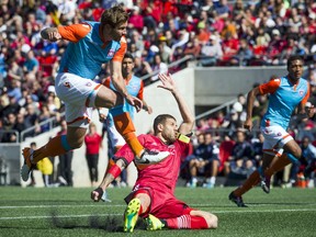 Miami FC's Brad Rusin flies over Ottawa Fury FC's Rafael Alves during the Fury's home opener Saturday, April 30, 2016 at TD Place.