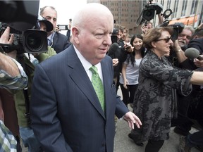 Sen. Mike Duffy leaves the courthouse with his wife Heather (right) after being acquitted on all charges, Thursday, April 21, 2016 in Ottawa.
