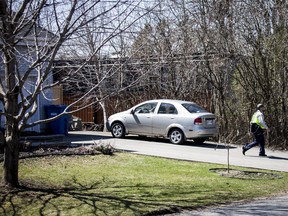A mailman leaves Karla Homolka's home on April 20 in Châteauguay, Que.