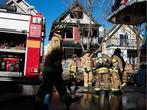 Ottawa firefighters wrap up there work at the scene of an early morning fire at 24 Spadina Ave. on Wednesday. The fire has been ruled accidental.