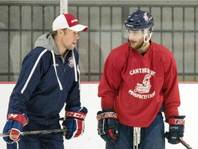 Ottawa Junior Senators assistant coach, Chris Kushneriuk, left, chats with team captain, Jim Pearson.