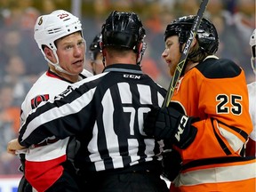 Chris Neil of the Ottawa Senators is held back as Ryan White of the Philadelphia Flyers gets in a few words in the third period at the Wells Fargo Center on Saturday, April 2, 2016 in Philadelphia.