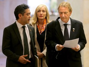 Owner of the Ottawa Senators, Eugene Melnyk (right), seemed in a serious mood as he headed into the National Capital Commission offices in downtown Ottawa to find out the fate of his bid for a downtown rink and development.