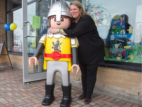 Patti Taggart, owner of Tag Along Toys in Kanata, with her new large size Playmobile Knight donated to her store by the manufacturer after her original was stolen from the store front last week.
