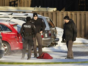 Police examine evidence at the scene on Claremont Drive after Mohamed Najdi was shot in January. Four men have been arrested in connection with his death.