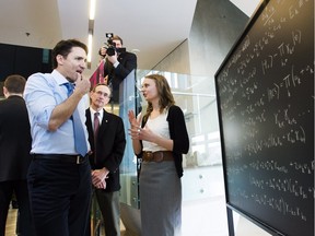 Prime Minister Justin Trudeau looks at a chalk board before making an announcement at the Perimeter Institute for Theoretical Physics in Waterloo, Ont., on Friday, April 15, 2016.