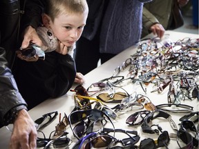 Six year old Drake Fischer-Wiskin took a good look through the shades at the OC Transpo Unclaimed Items Sale brought in huge crowds Saturday April 30, 2016.   Ashley Fraser