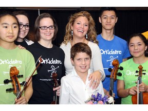 Sophie Grégoire-Trudeau and her eldest son, Xavier, eight, seen with members of free music program OrKidstra following the young musicians' performance at Ottawa City Hall on Wednesday, April 6, 2016, as part of the 20th anniversary celebration of the Debra Dynes Family House.