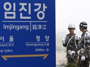 South Korean soldiers walk by a signboard showing the distance to the North Korea's capital Pyongyang and to South Korea's capital Seoul from Imjingang Station near the border village of the Panmunjom in Paju, South Korea, Saturday, April 9, 2016. North Korea said Saturday it has successfully tested a new intercontinental ballistic rocket engine that will give it the ability to stage nuclear strikes on the United States.