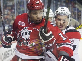 Stephen Harper of the Niagara IceDogs and Ryan Orban of the Ottawa 67s fight for the puck, Friday, April 1, 2016.