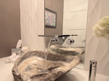 2nd place, powder room: A one-of-a-kind stone sink paired with a waterfall faucet mounted into the mirror is the show-stopper in this room by Julia Enriquez of Astro Design Centre.